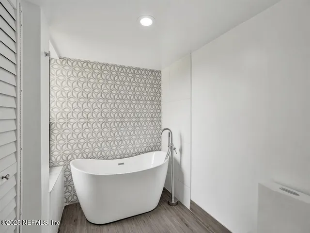 a bathroom with a bathtub and shower