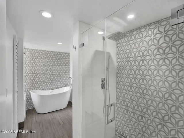 a bathroom with a bathtub and shower