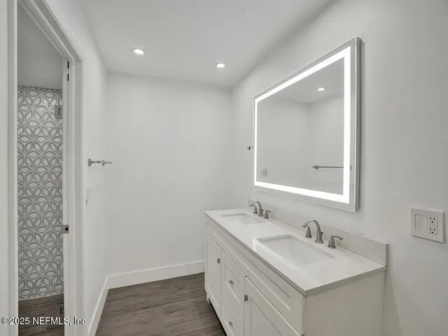 a bathroom with a sink a mirror and a shower