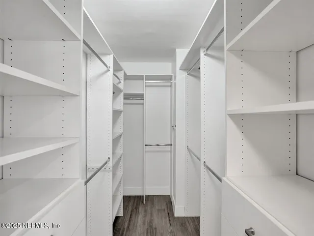 a view of walk in closet with empty racks