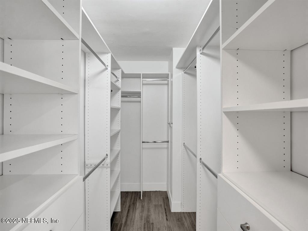 5851 Camino Del Sol, Unit 305 Boca Raton, FL 33433 - Photo 28 of 47 a view of walk in closet with empty racks