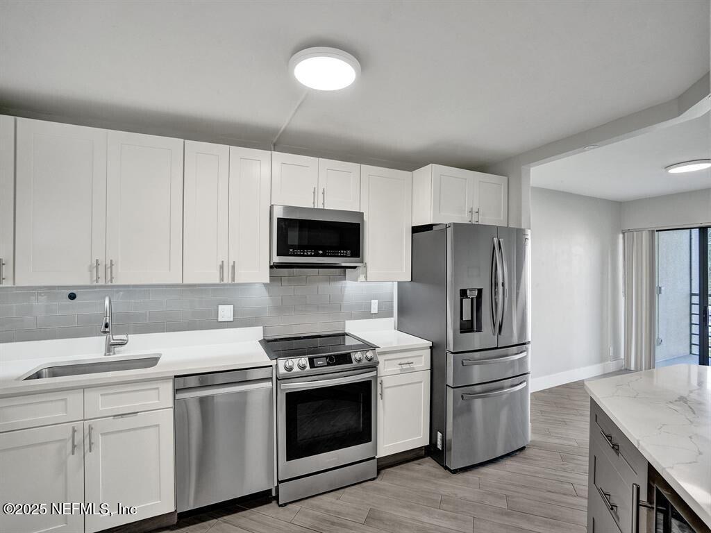 5851 Camino Del Sol, Unit 305 Boca Raton, FL 33433 - Photo 3 of 47 a kitchen with a sink appliances and cabinets