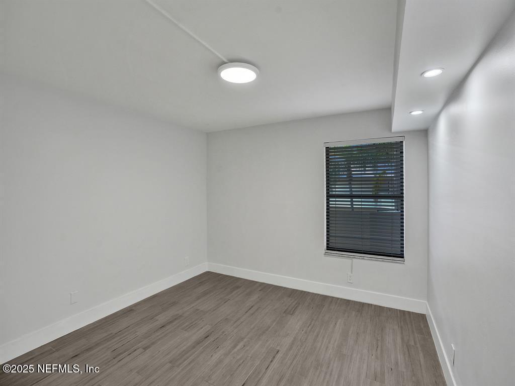 5851 Camino Del Sol, Unit 305 Boca Raton, FL 33433 - Photo 31 of 47 wooden floor in an empty room with a window