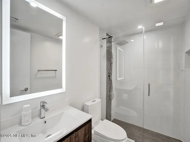 a bathroom with a sink toilet and shower
