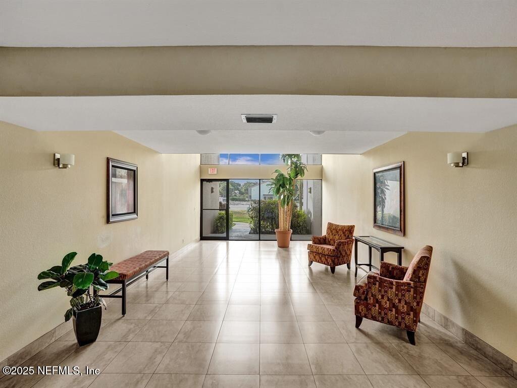 5851 Camino Del Sol, Unit 305 Boca Raton, FL 33433 - Photo 40 of 47 a living room with furniture and potted plants