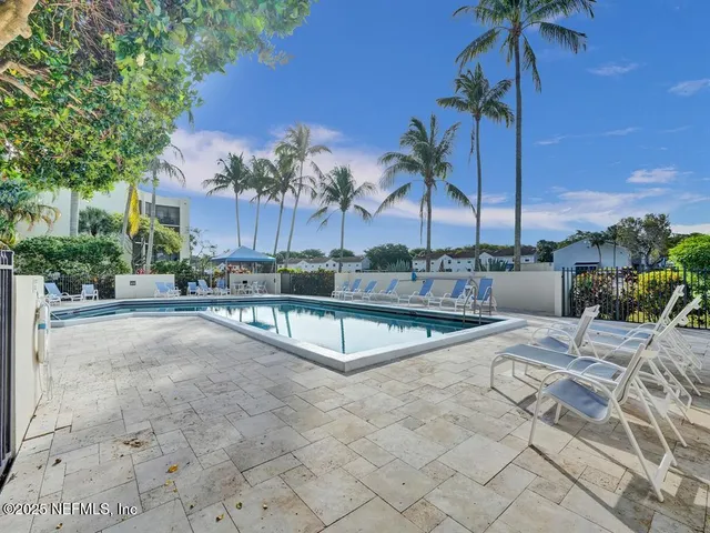 a view of swimming pool with outdoor seating and a yard