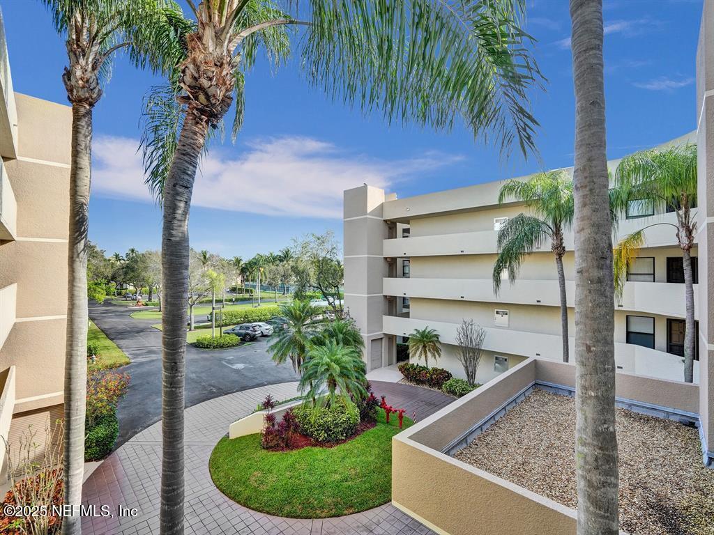 5851 Camino Del Sol, Unit 305 Boca Raton, FL 33433 - Photo 47 of 47 a view of a backyard with plants and palm tree
