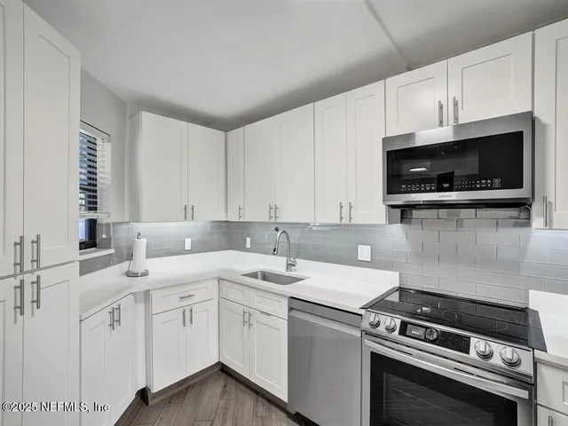 a kitchen with a sink stove and microwave