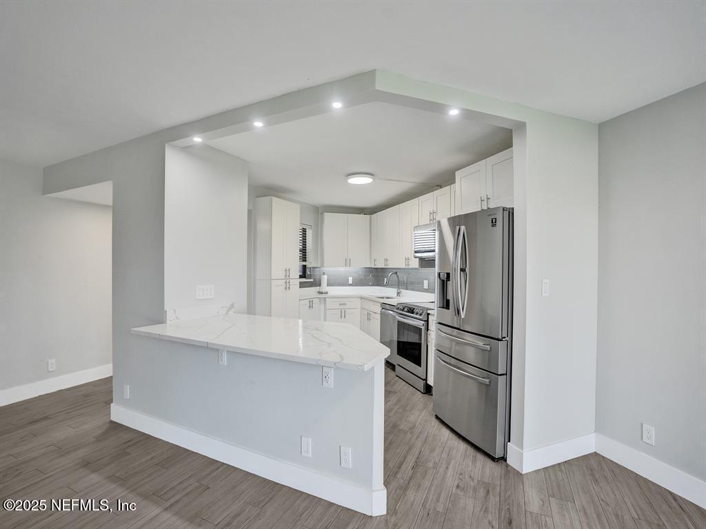 5851 Camino Del Sol, Unit 305 Boca Raton, FL 33433 - Photo 10 of 47 a kitchen with refrigerator and cabinets
