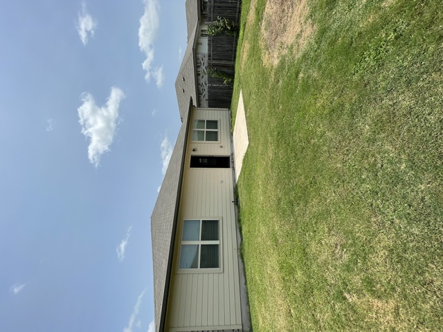 12401 Amber Lynn Path Manor, TX 78653 - Photo 30 of 33 A well-kept green space extends from a tidy residential structure.
