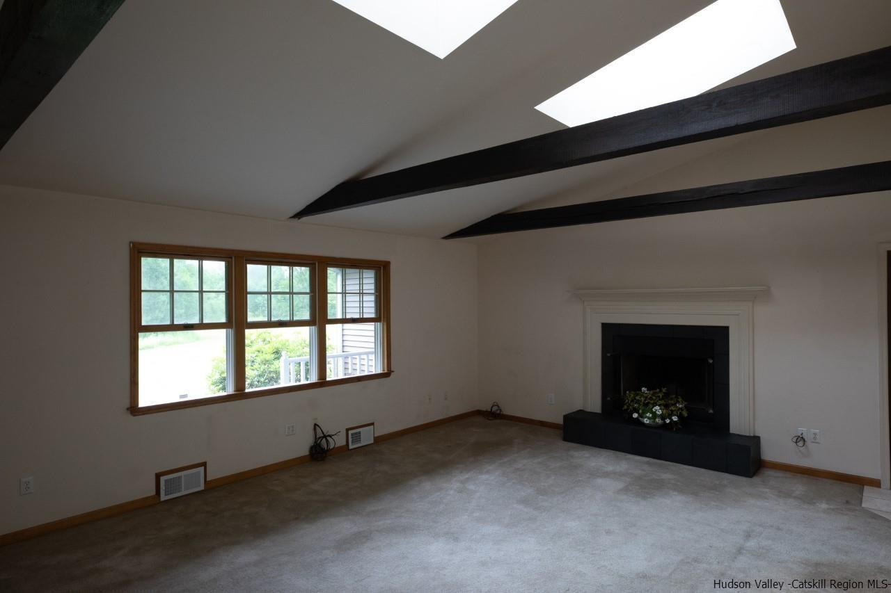 144 Burnt Meadows Road Gardiner, NY 12525 - Photo 14 of 31 a view of an empty room with a fireplace and a window