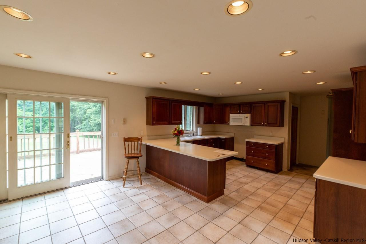 144 Burnt Meadows Road Gardiner, NY 12525 - Photo 15 of 31 a large kitchen with stainless steel appliances granite countertop a large counter top and a stove top oven