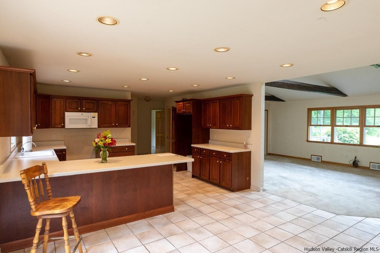 144 Burnt Meadows Road Gardiner, NY 12525 - Photo 17 of 31 a large living room with stainless steel appliances kitchen island granite countertop a large counter top space and a sink