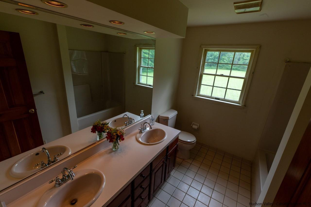 144 Burnt Meadows Road Gardiner, NY 12525 - Photo 24 of 31 a bathroom with a granite countertop sink and a mirror