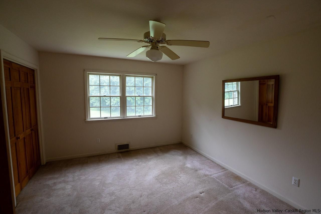 144 Burnt Meadows Road Gardiner, NY 12525 - Photo 25 of 31 an empty room with windows and fan