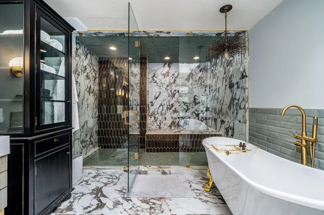 a bathroom with a bathtub and shower