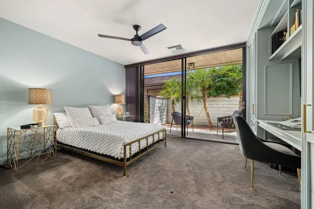 a spacious bedroom with a bed and a large window