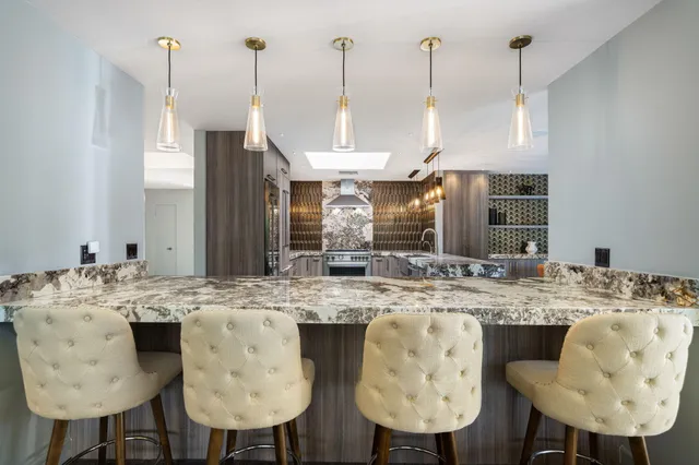 a dining table chairs and a chandelier