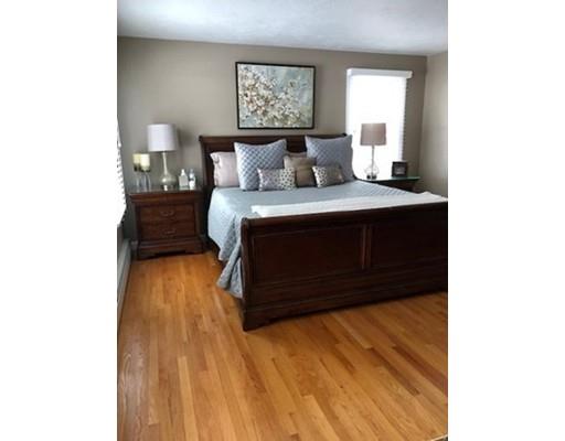 24 Birch Brush Road Shrewsbury, MA 01545 - Photo 11 of 27 a bedroom with a bed and a lamp on table