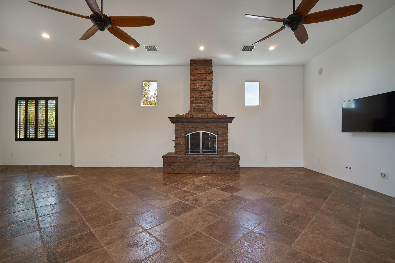 695 West Racquet Club Road Palm Springs, CA 92262 - Photo 11 of 50 a view of an empty room with a fireplace and a window
