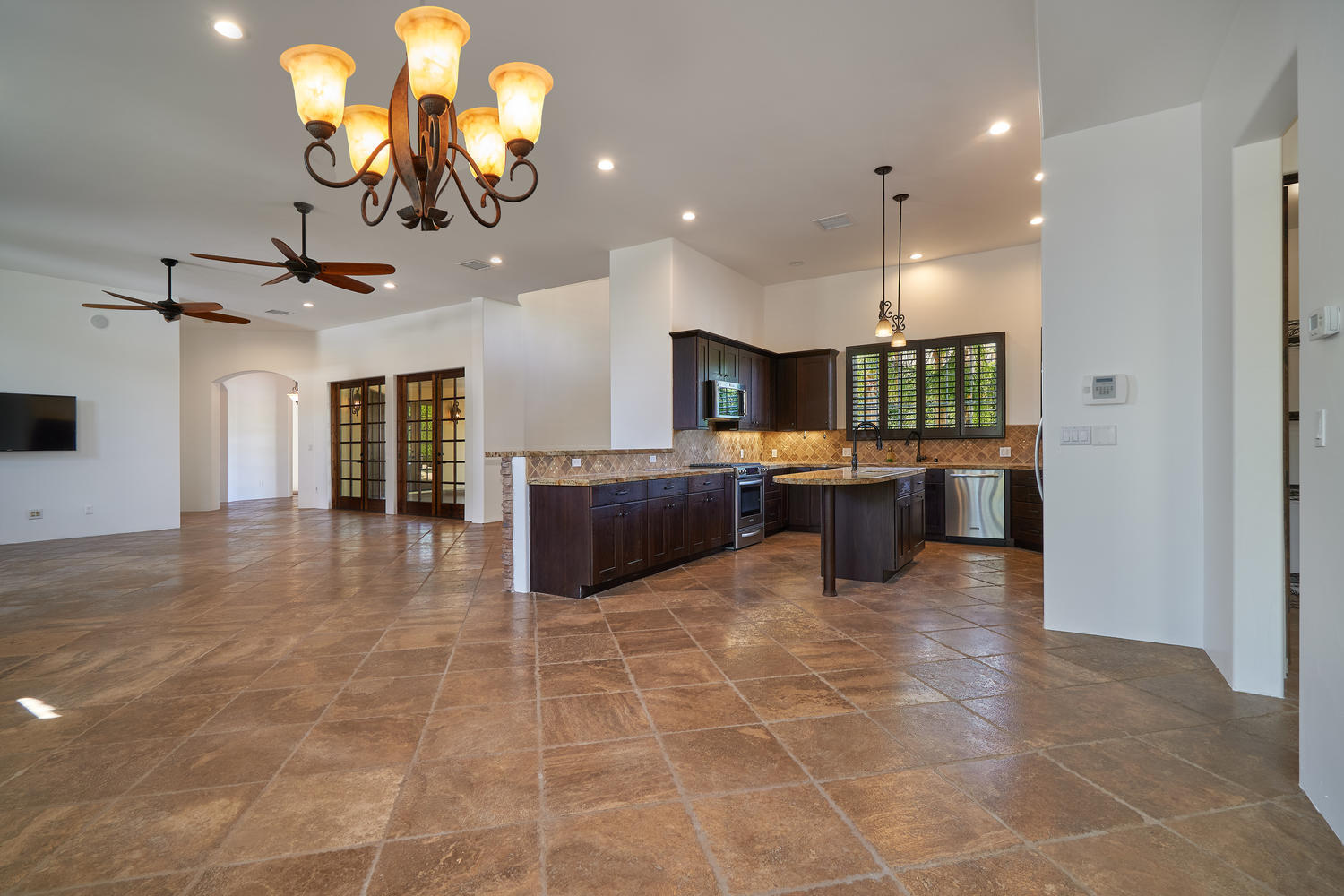 695 West Racquet Club Road Palm Springs, CA 92262 - Photo 14 of 50 a large kitchen with a counter space appliances and a chandelier