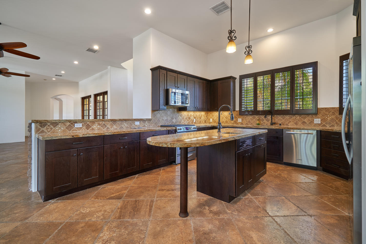 695 West Racquet Club Road Palm Springs, CA 92262 - Photo 16 of 50 a kitchen with a sink a stove a refrigerator and a oven