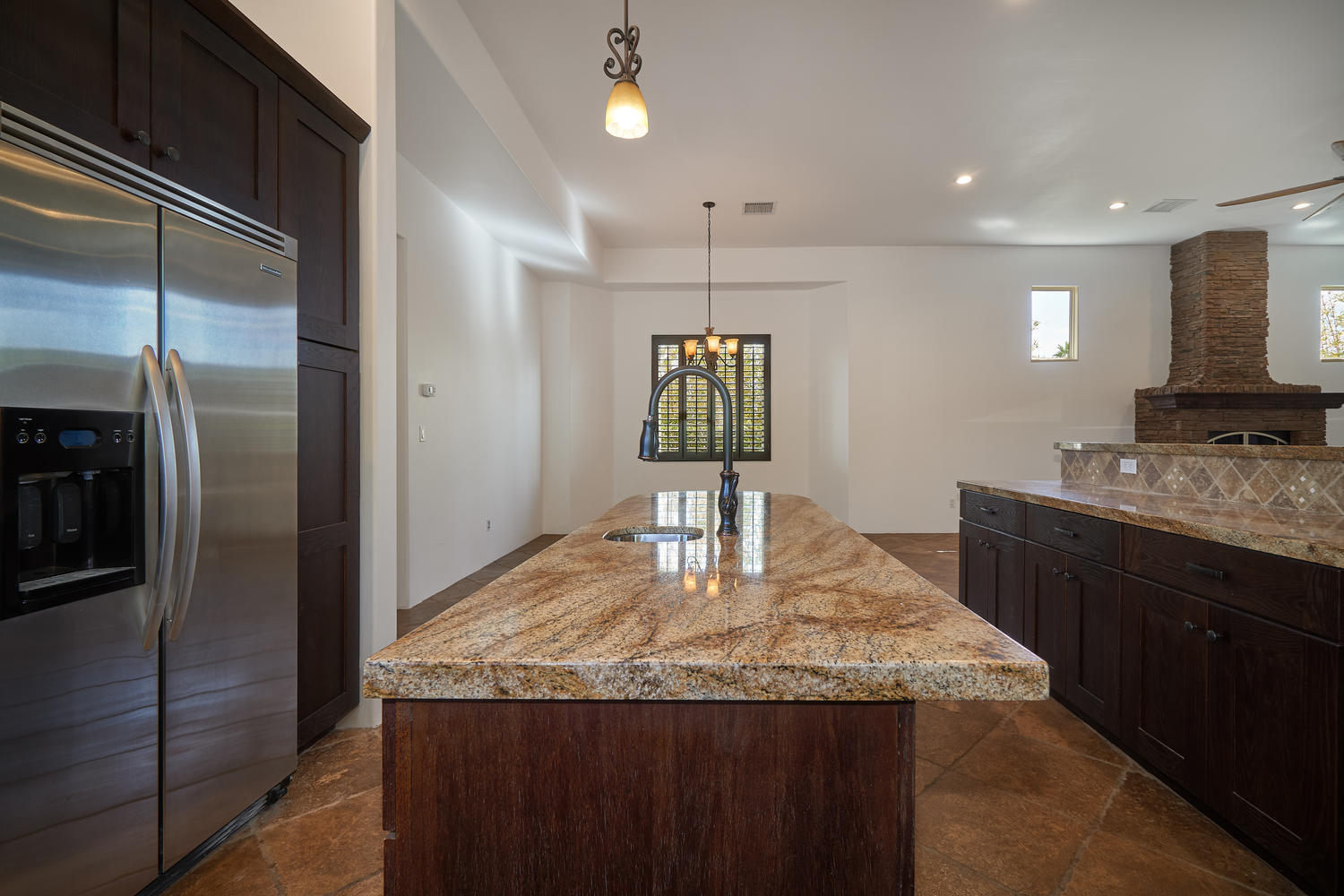 695 West Racquet Club Road Palm Springs, CA 92262 - Photo 17 of 50 a kitchen with granite countertop kitchen island stainless steel appliances a sink stove and refrigerator