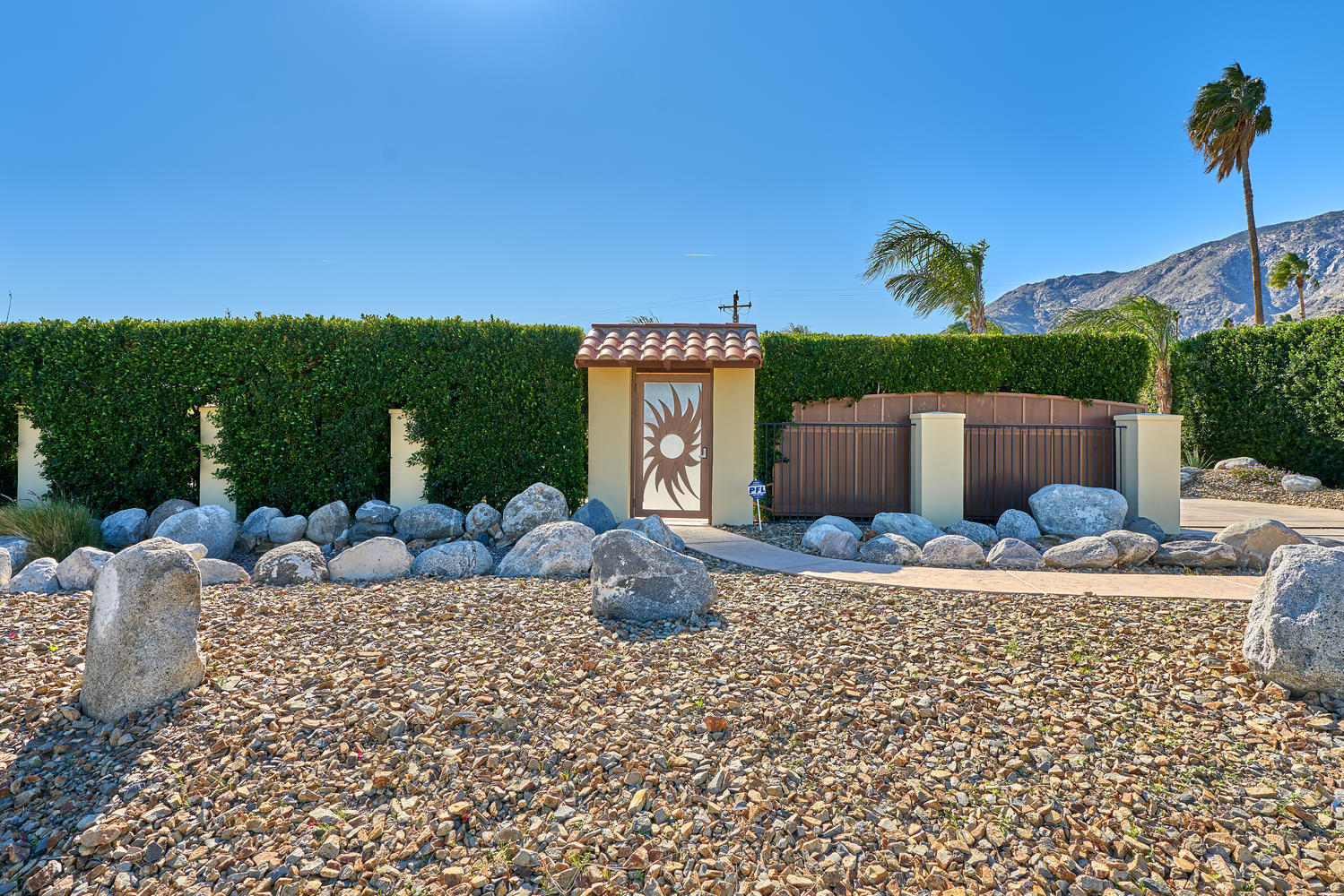 695 West Racquet Club Road Palm Springs, CA 92262 - Photo 3 of 50 a front view of a house with garden