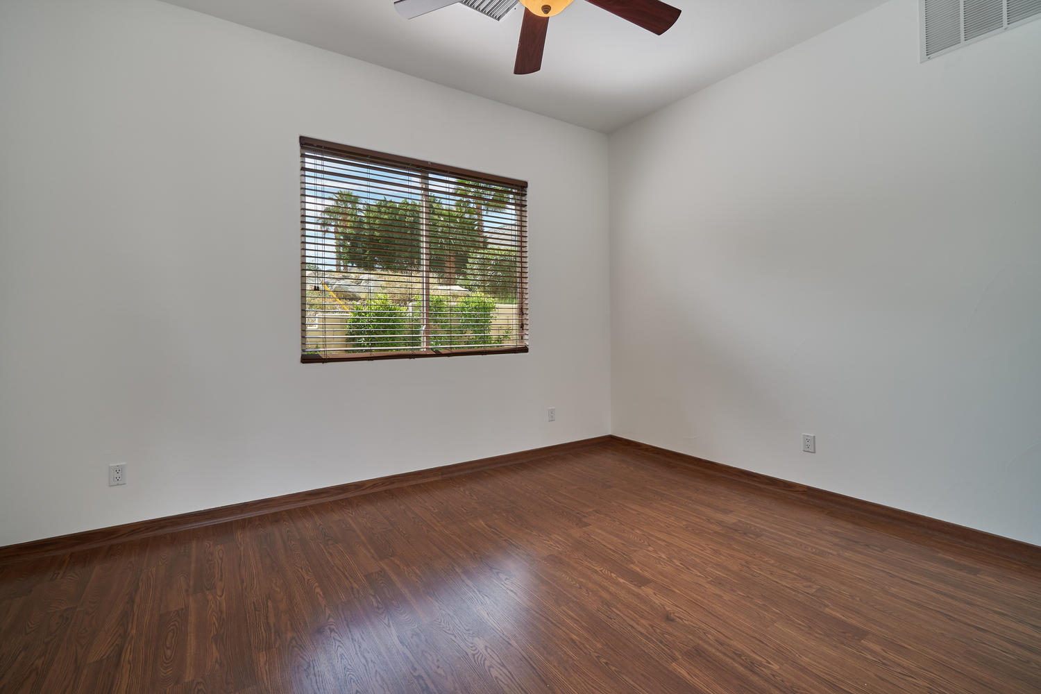 695 West Racquet Club Road Palm Springs, CA 92262 - Photo 38 of 50 an empty room with wooden floor and windows