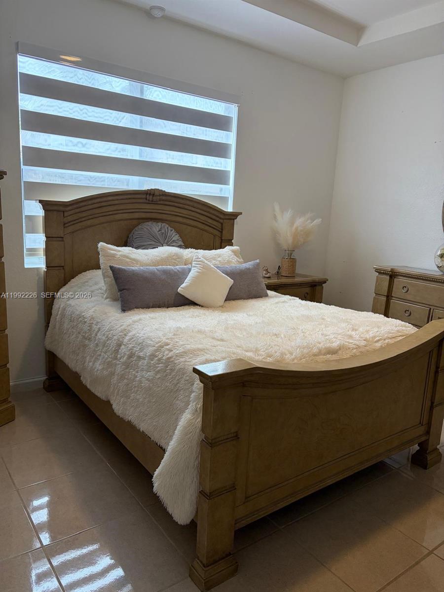 a bedroom with a bed and window
