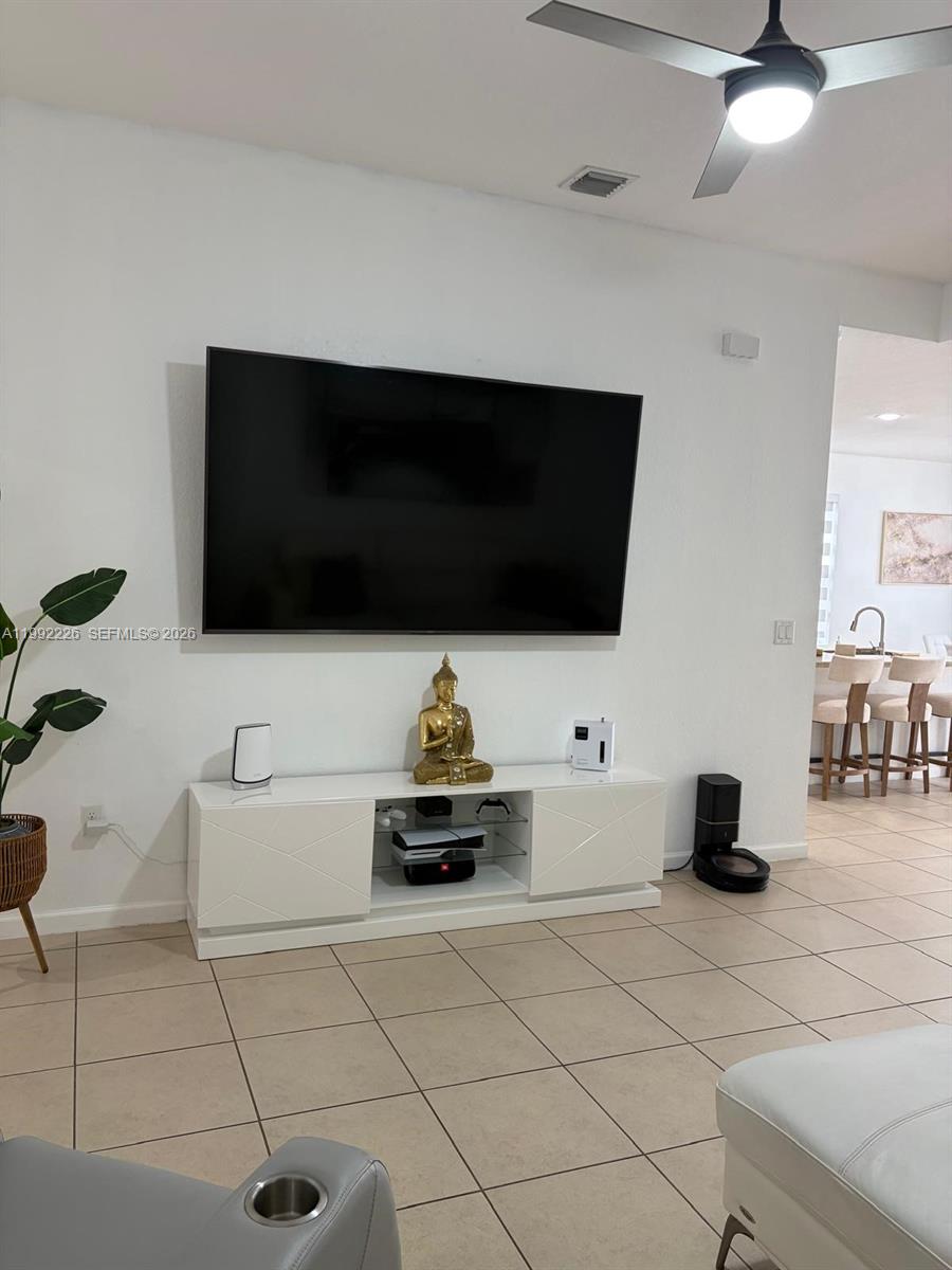 24982 Southwest 118th Court Homestead, FL 33032 - Photo 11 of 51 a living room with furniture and a flat screen tv