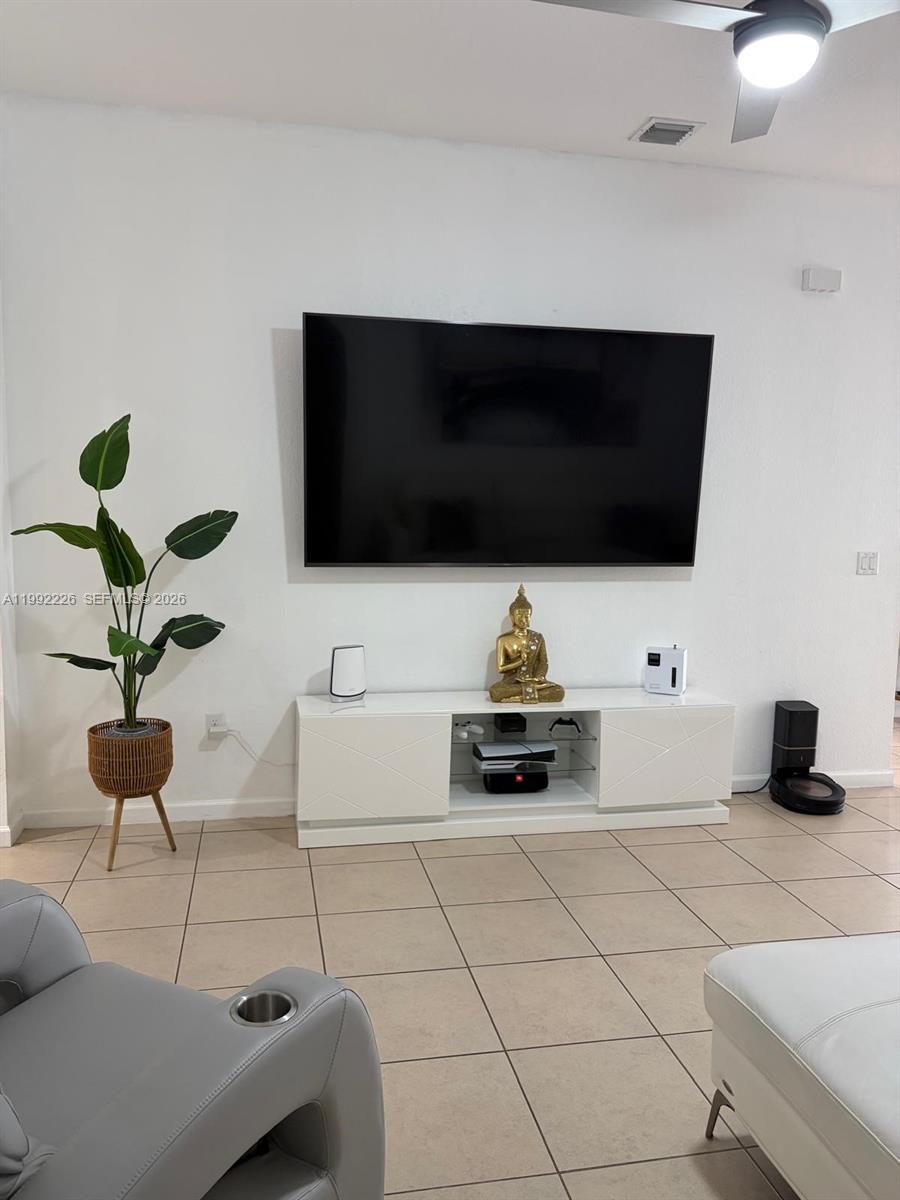 24982 Southwest 118th Court Homestead, FL 33032 - Photo 12 of 51 a living room with furniture and a flat screen tv
