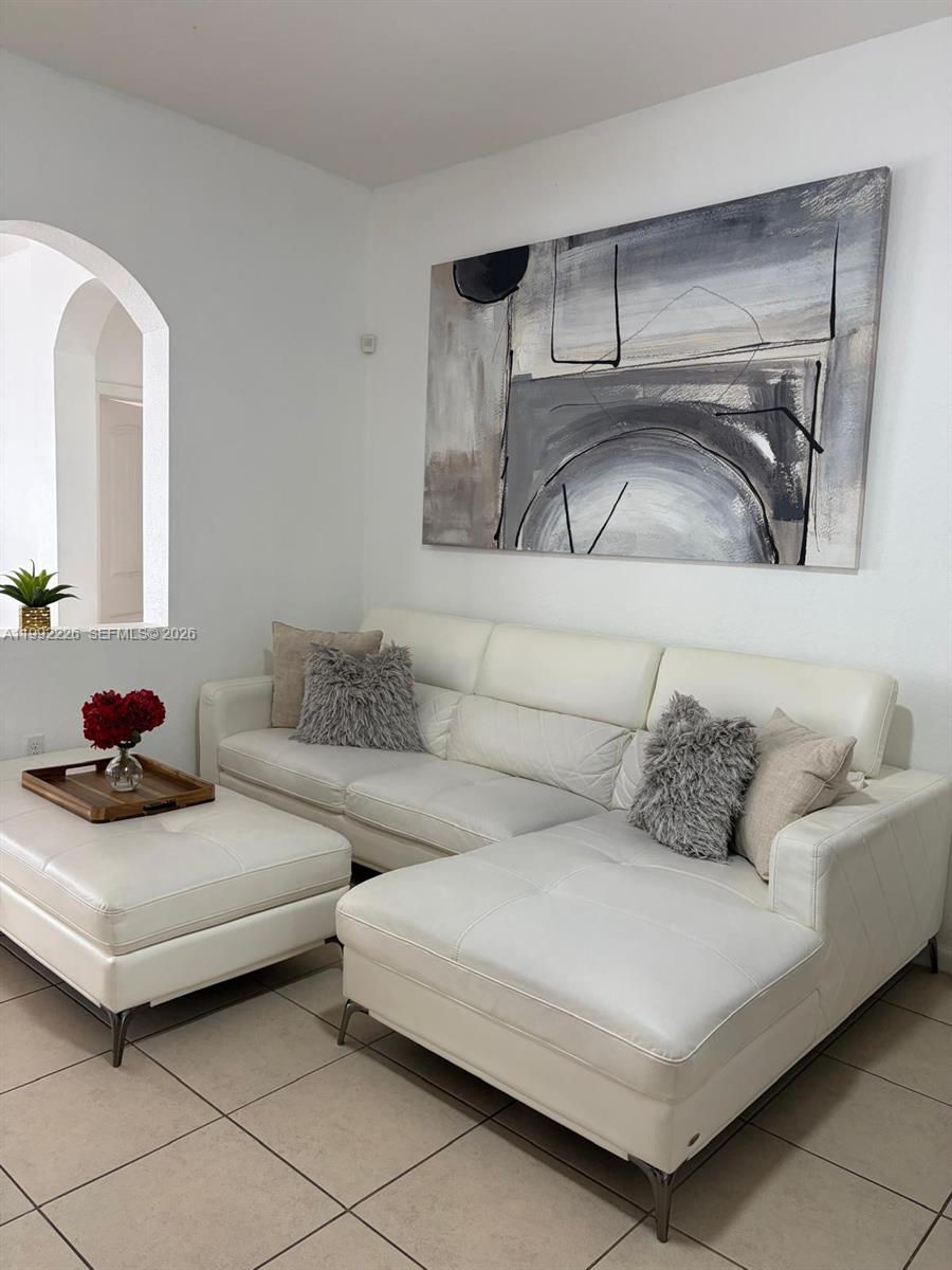 24982 Southwest 118th Court Homestead, FL 33032 - Photo 14 of 51 a living room with furniture and a couch