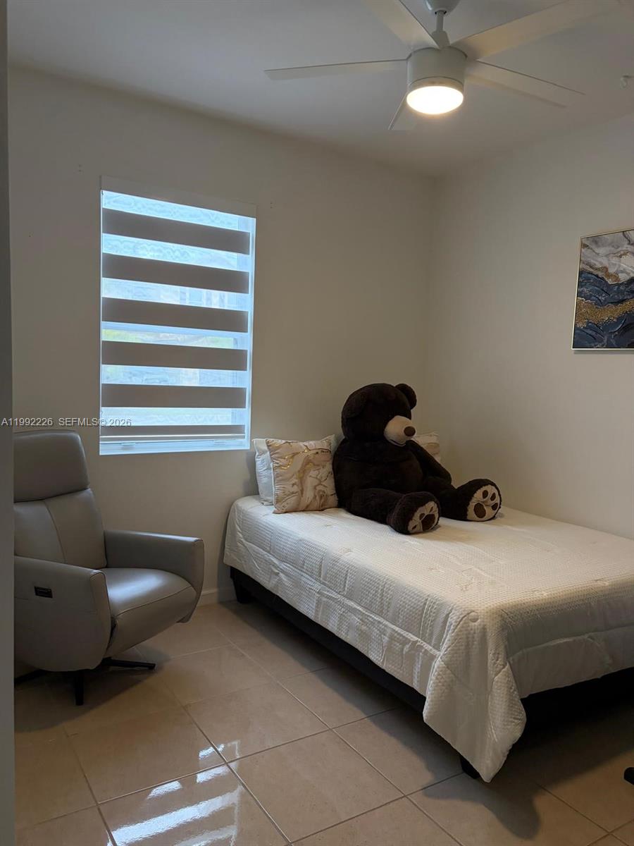 24982 Southwest 118th Court Homestead, FL 33032 - Photo 20 of 51 a bedroom with a bed and a couch