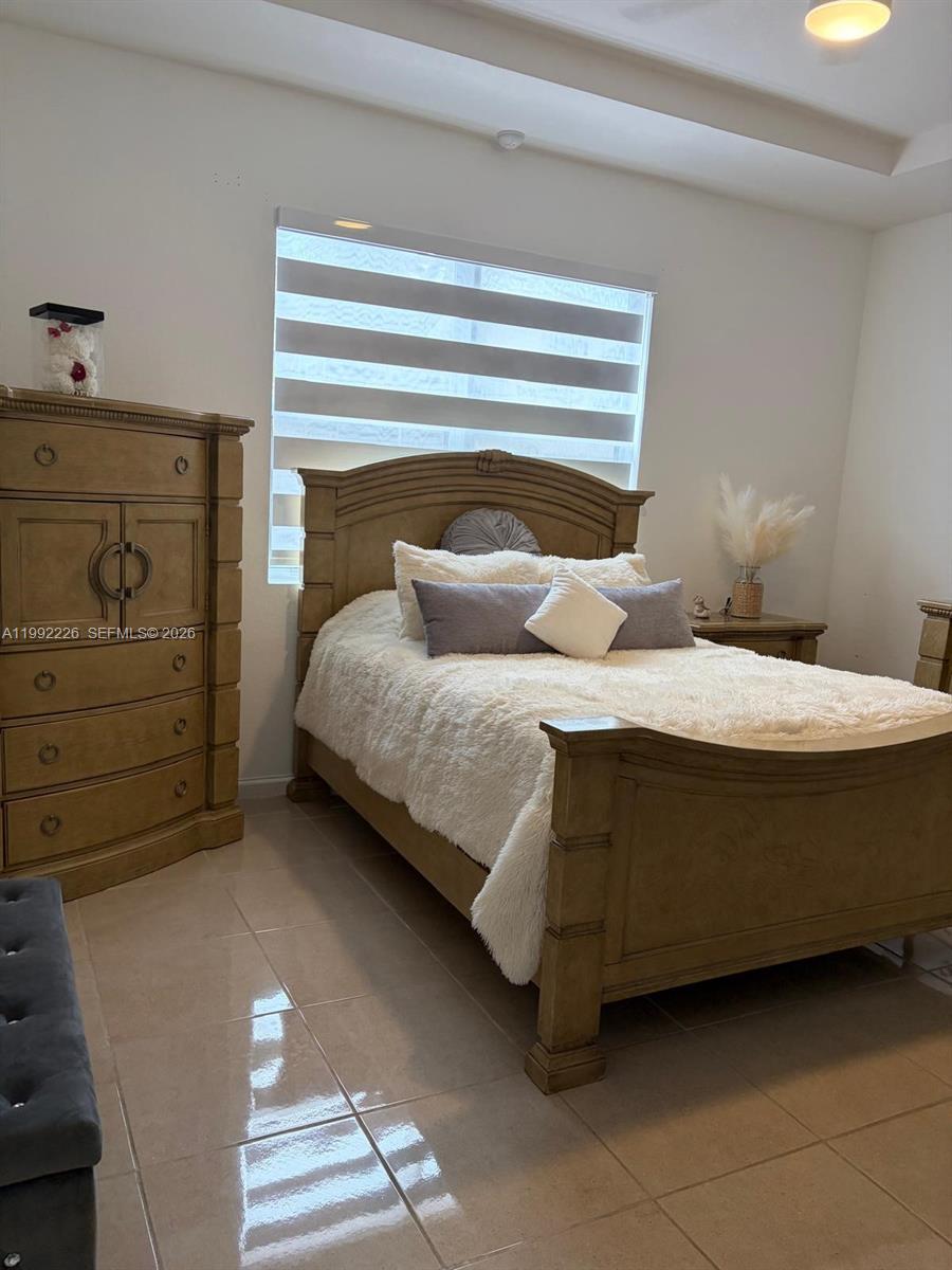 24982 Southwest 118th Court Homestead, FL 33032 - Photo 2 of 51 a bedroom with a bed and window