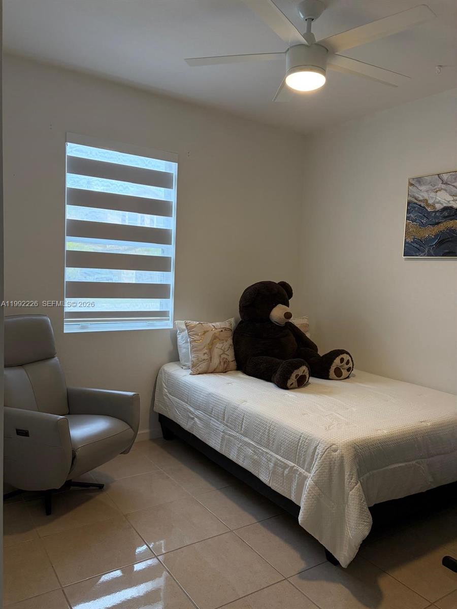 24982 Southwest 118th Court Homestead, FL 33032 - Photo 21 of 51 a bedroom with a bed and a couch