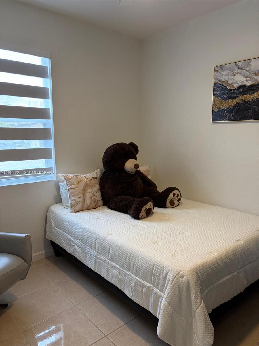 24982 Southwest 118th Court Homestead, FL 33032 - Photo 22 of 51 a bedroom with a bed and a couch