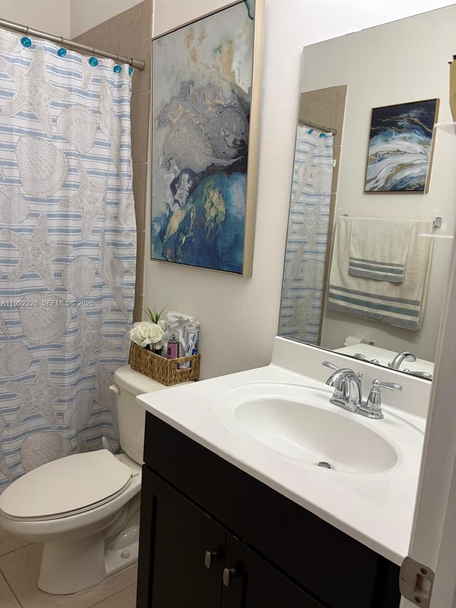24982 Southwest 118th Court Homestead, FL 33032 - Photo 24 of 51 a bathroom with a sink mirror vanity and toilet