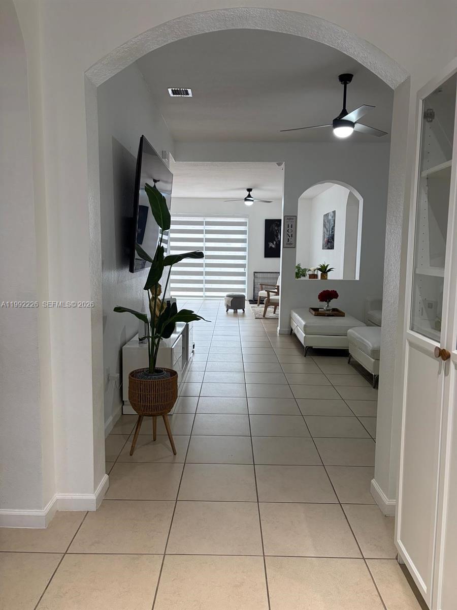 24982 Southwest 118th Court Homestead, FL 33032 - Photo 25 of 51 a living room with couches and a potted plant on coffee table