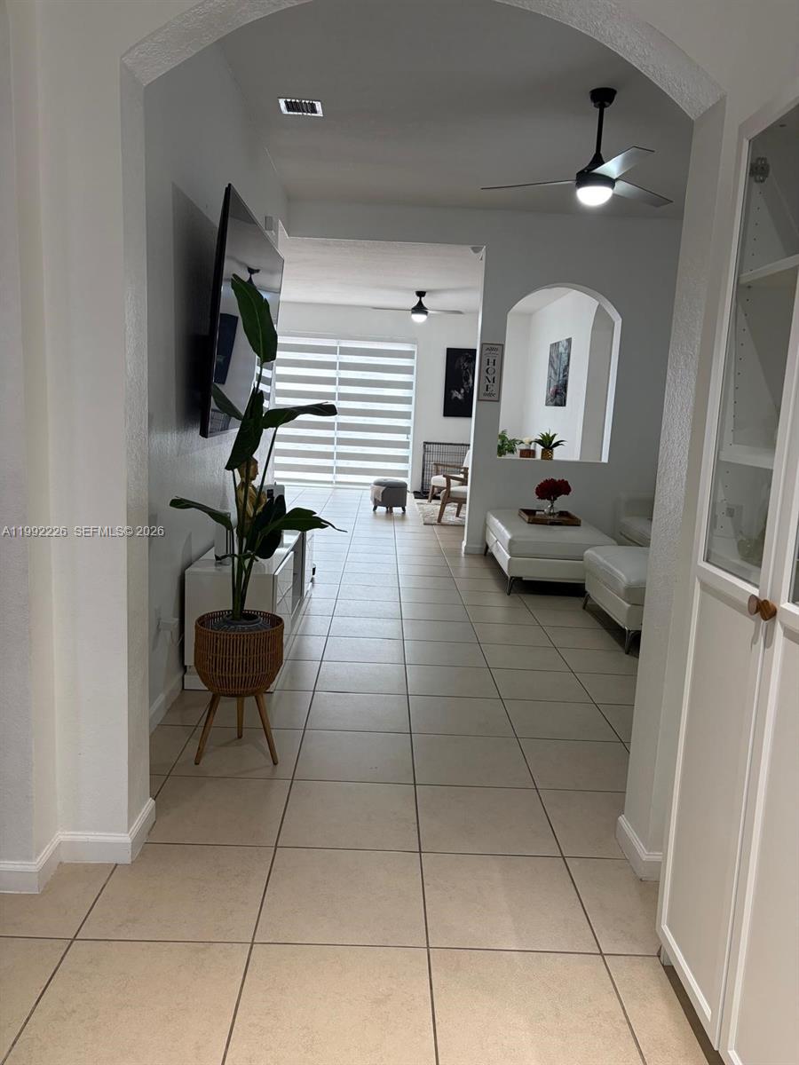 24982 Southwest 118th Court Homestead, FL 33032 - Photo 27 of 51 a living room with furniture and a potted plant