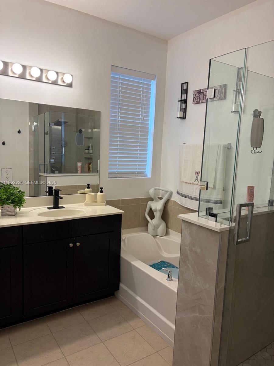 24982 Southwest 118th Court Homestead, FL 33032 - Photo 3 of 51 a bathroom with a tub sink and mirror