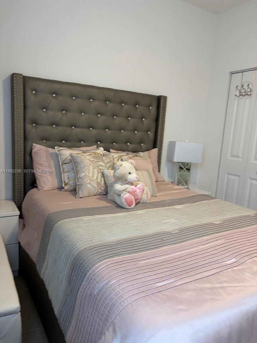 24982 Southwest 118th Court Homestead, FL 33032 - Photo 33 of 51 a bedroom with a bed and wooden floor