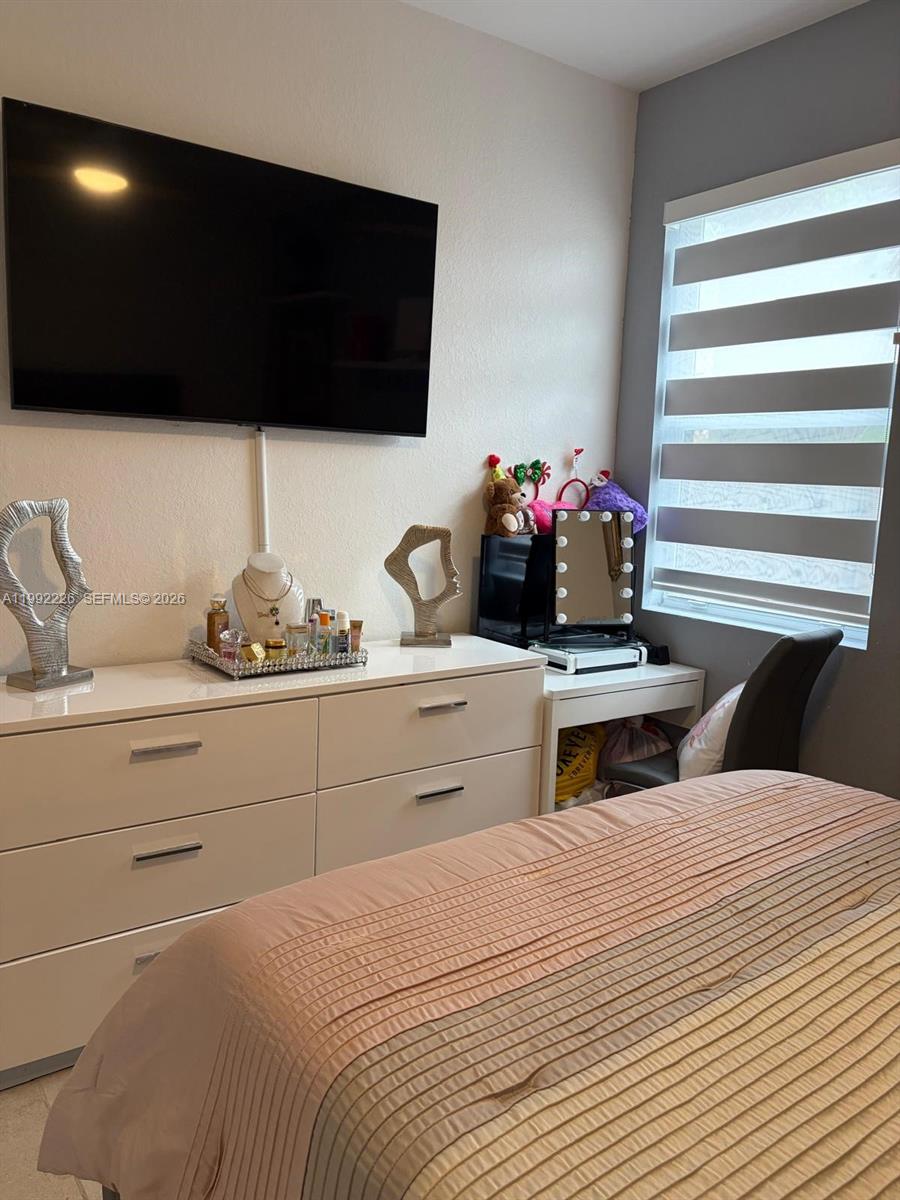 24982 Southwest 118th Court Homestead, FL 33032 - Photo 35 of 51 a bedroom with a bed and a flat tv screen
