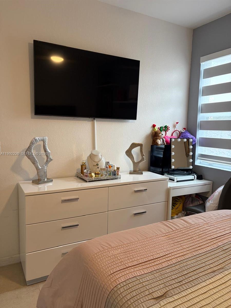 24982 Southwest 118th Court Homestead, FL 33032 - Photo 36 of 51 a bedroom with a bed and a flat screen tv