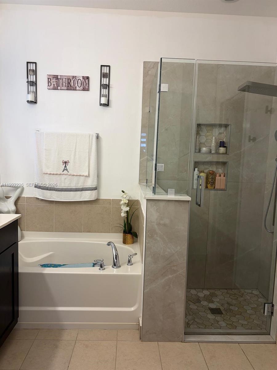 24982 Southwest 118th Court Homestead, FL 33032 - Photo 4 of 51 a bathroom with a bathtub and a shower