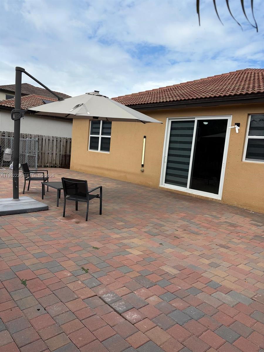 24982 Southwest 118th Court Homestead, FL 33032 - Photo 42 of 51 a view of a house with backyard porch and sitting area