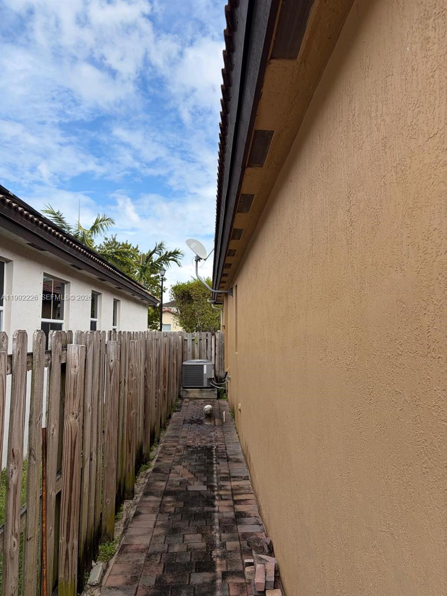 24982 Southwest 118th Court Homestead, FL 33032 - Photo 45 of 51 a view of a pathway of a house with wooden fence