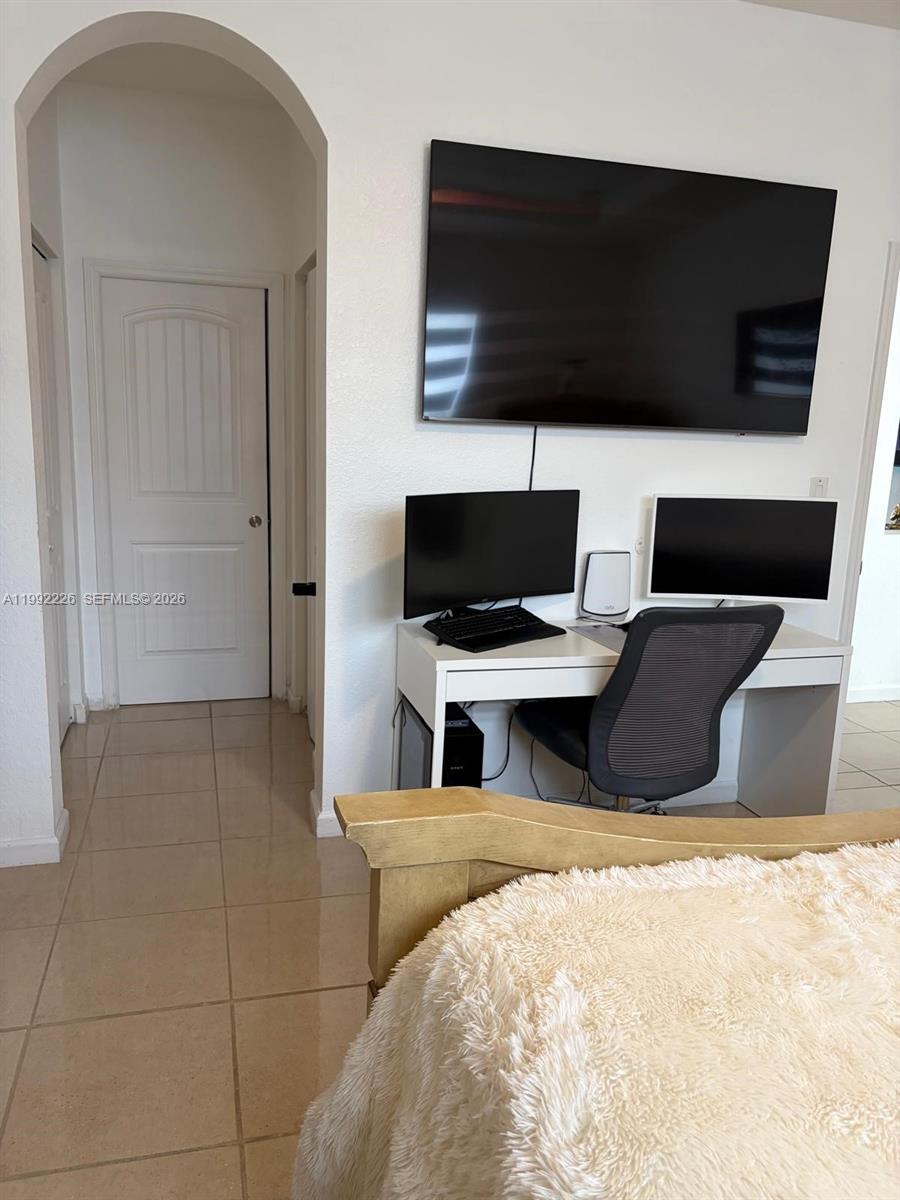 24982 Southwest 118th Court Homestead, FL 33032 - Photo 6 of 51 a bedroom with a bed and a flat screen tv