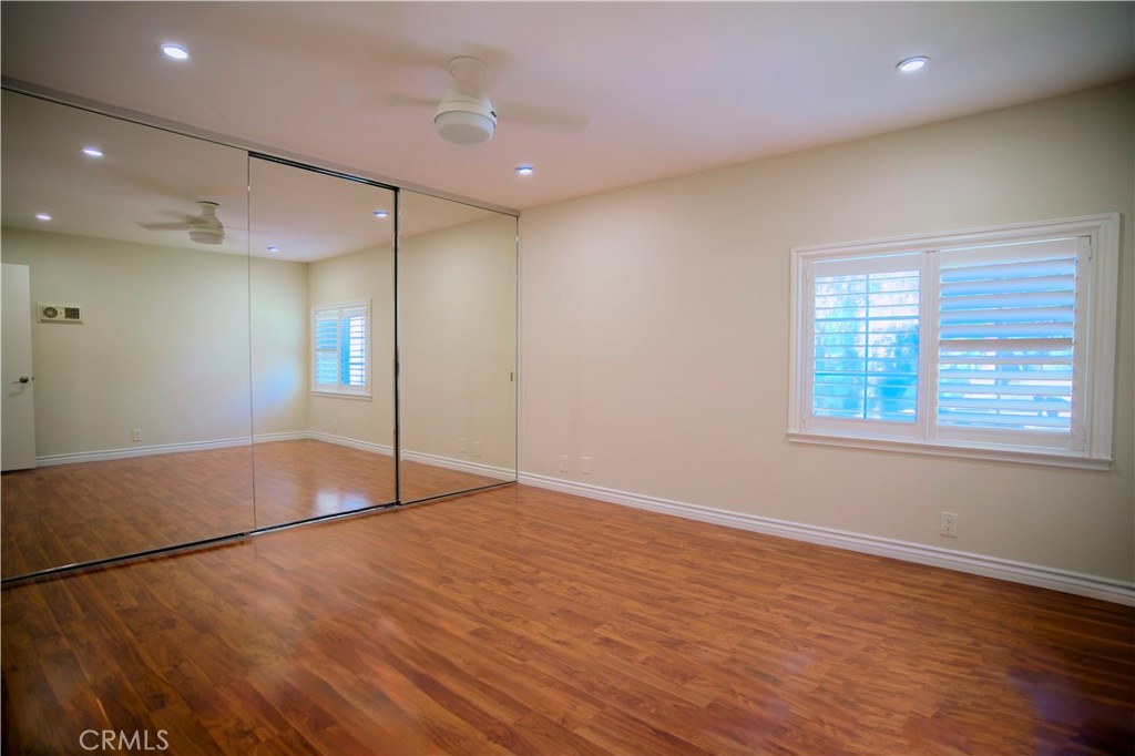 10 Raleigh Irvine, CA 92604 - Photo 14 of 30 an empty room with wooden floor and windows