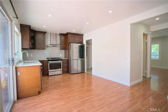 a kitchen with stainless steel appliances a refrigerator and a stove top oven